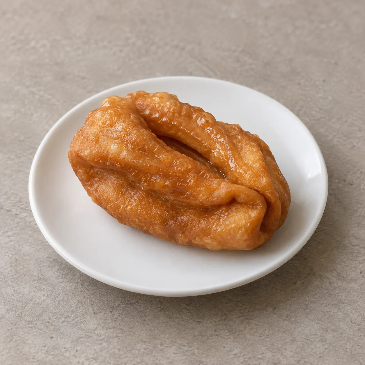 Illustration of Tang Erduo, a folded ear-shaped fried pastry with a glossy syrup coating.